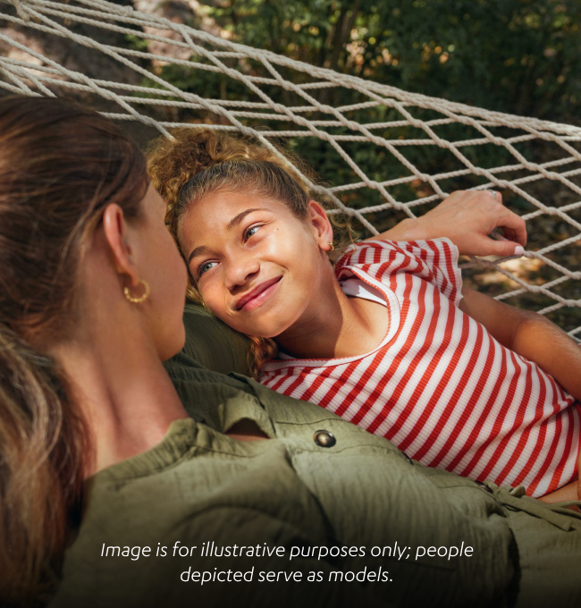Woman and child laying in a hammock smiling