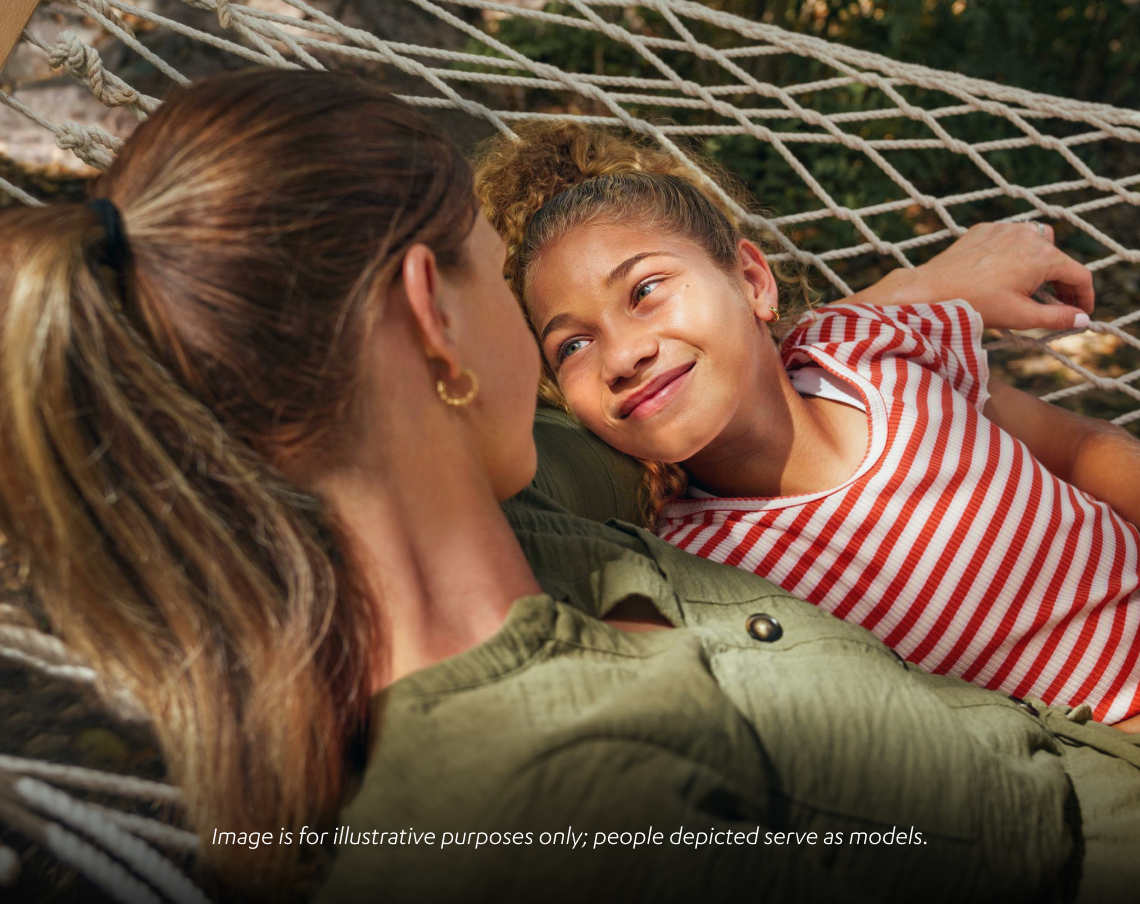 Woman and child laying in a hammock smiling
