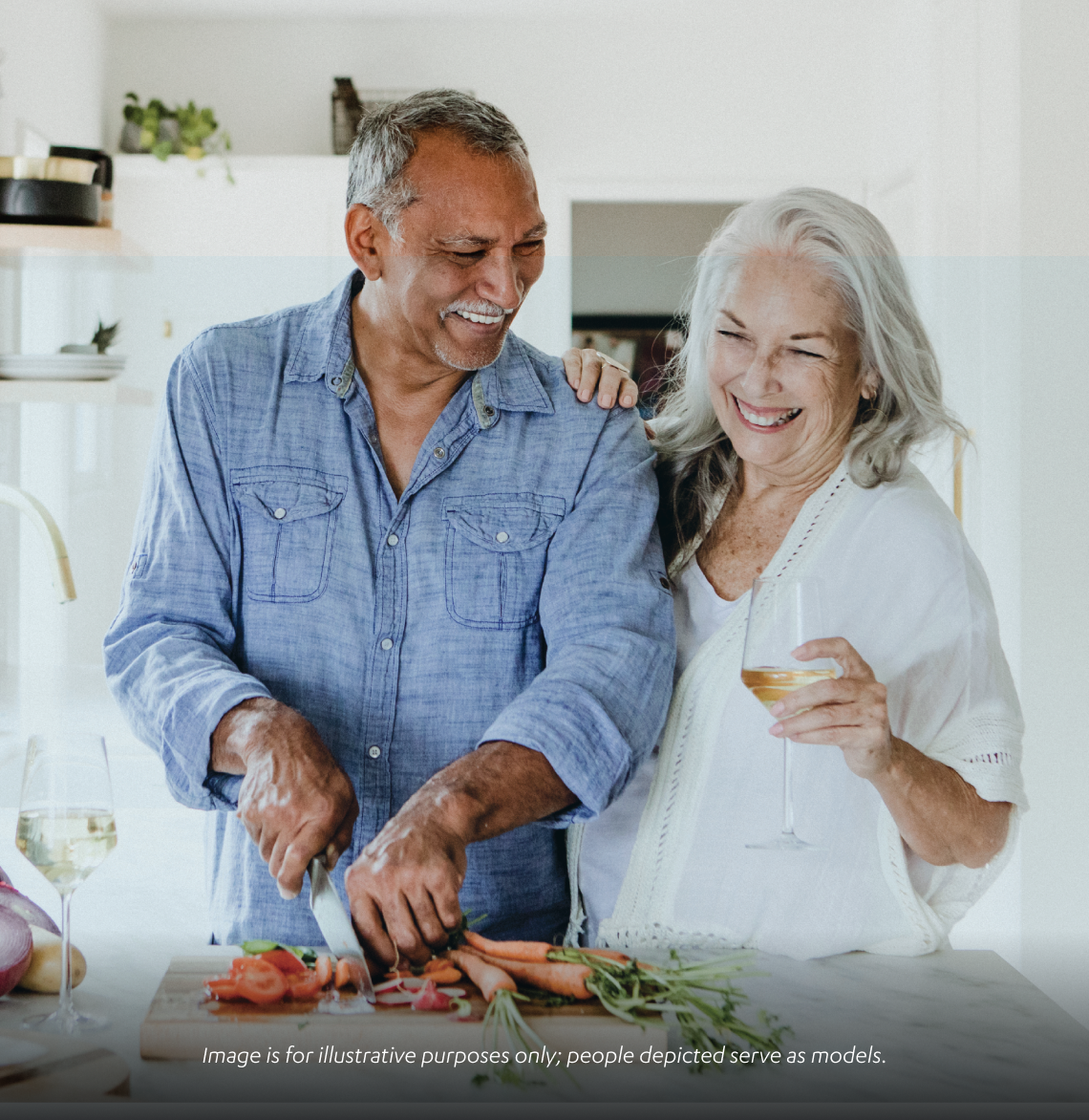 Couple smiling and cooking together 