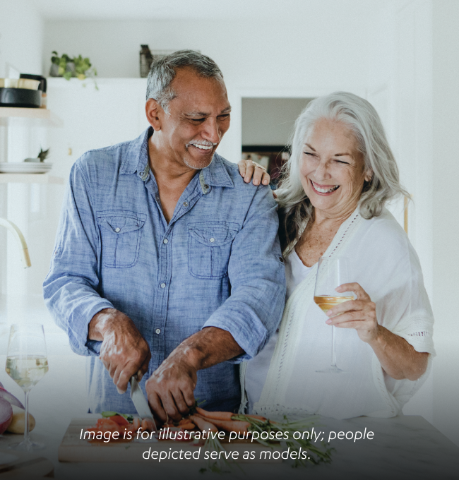 Couple smiling and cooking together 